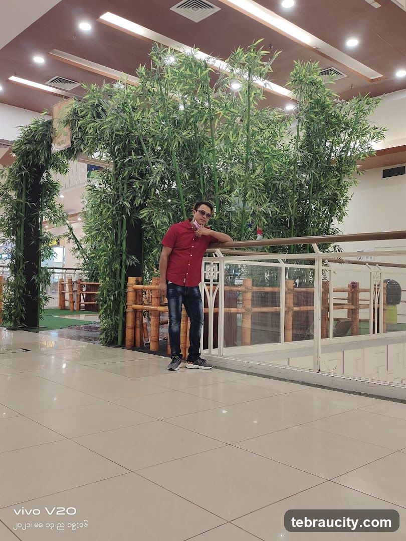 Man Posing by Bamboo Decor