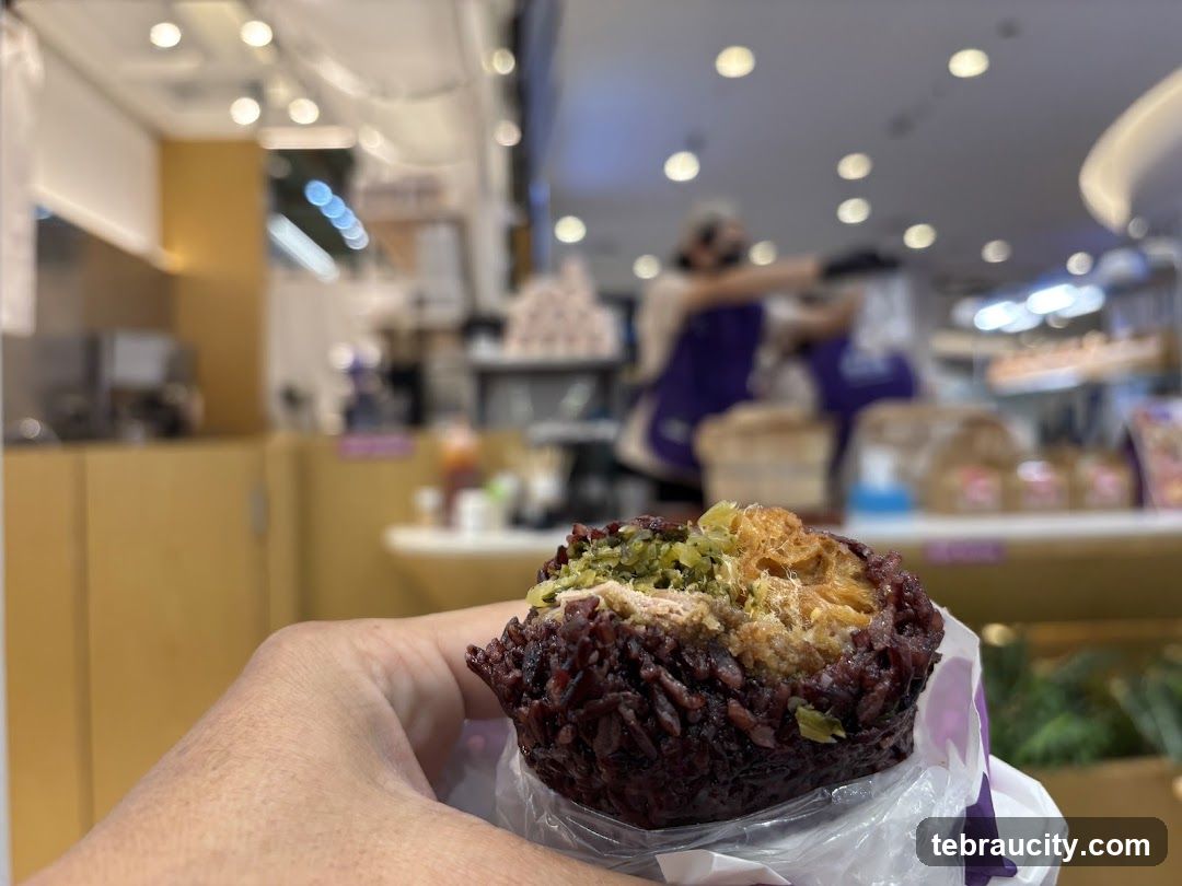 Hand holding food item in store interior