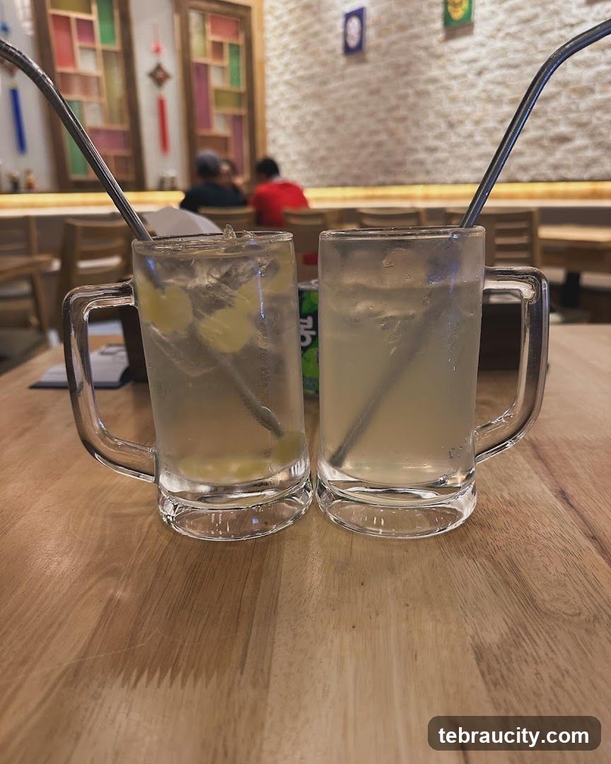 Two mugs of iced drink on wooden table