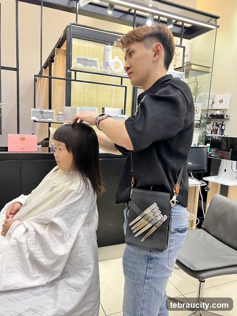 Hairdresser cutting a child's hair
