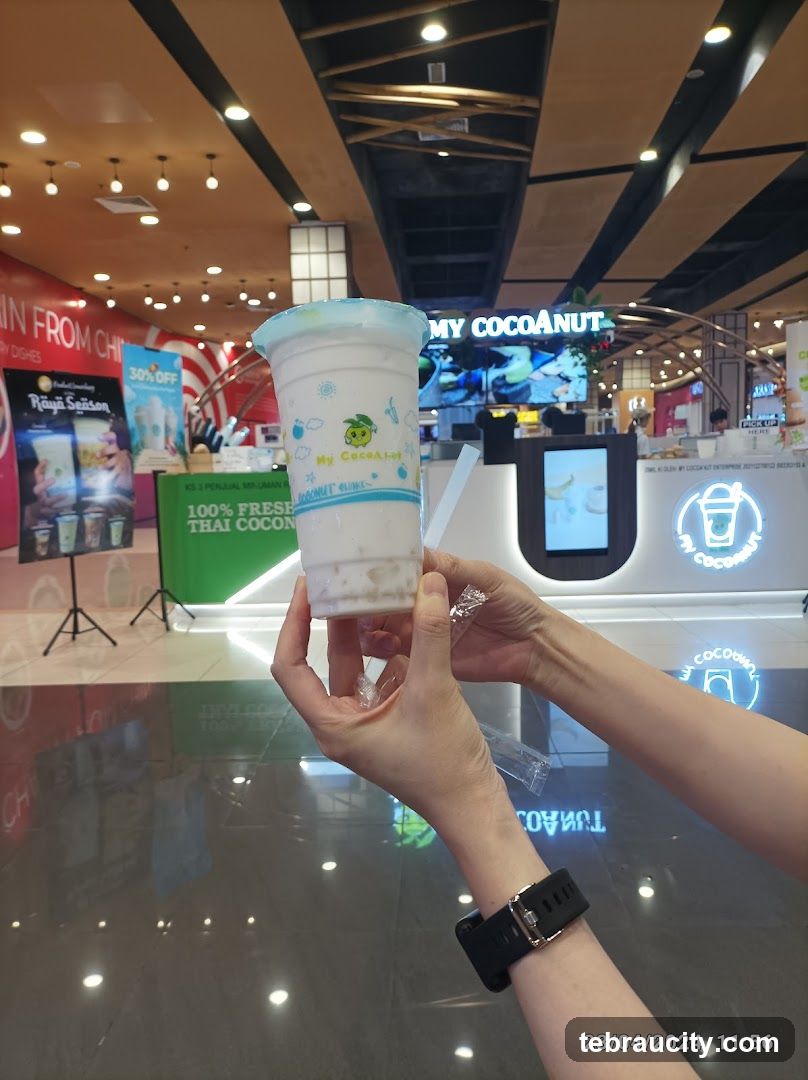 Person holding a coconut drink