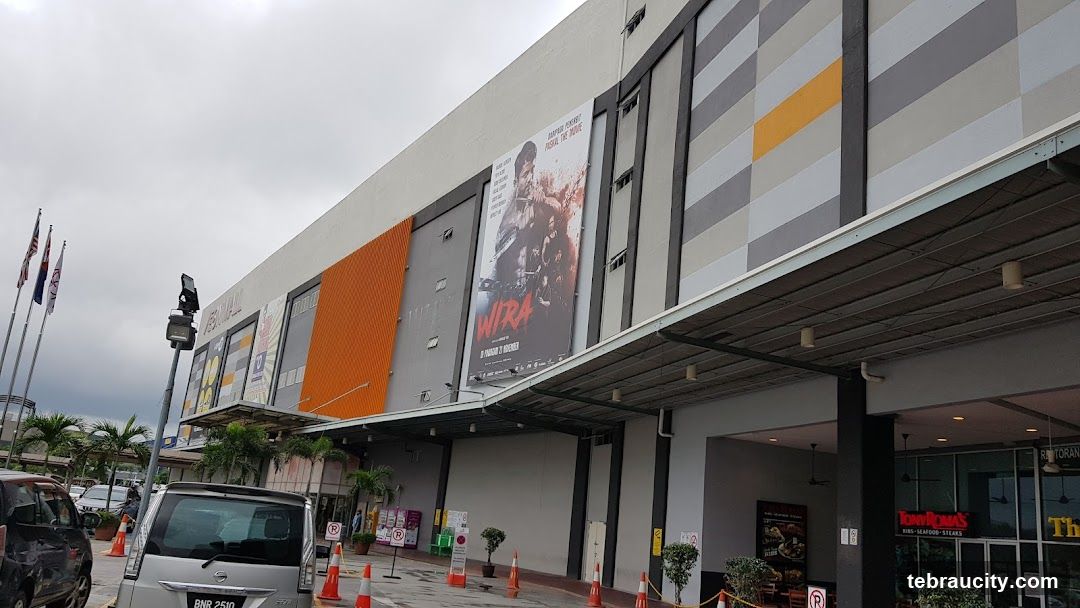 Mall Exterior with Movie Poster and Restaurant Signage