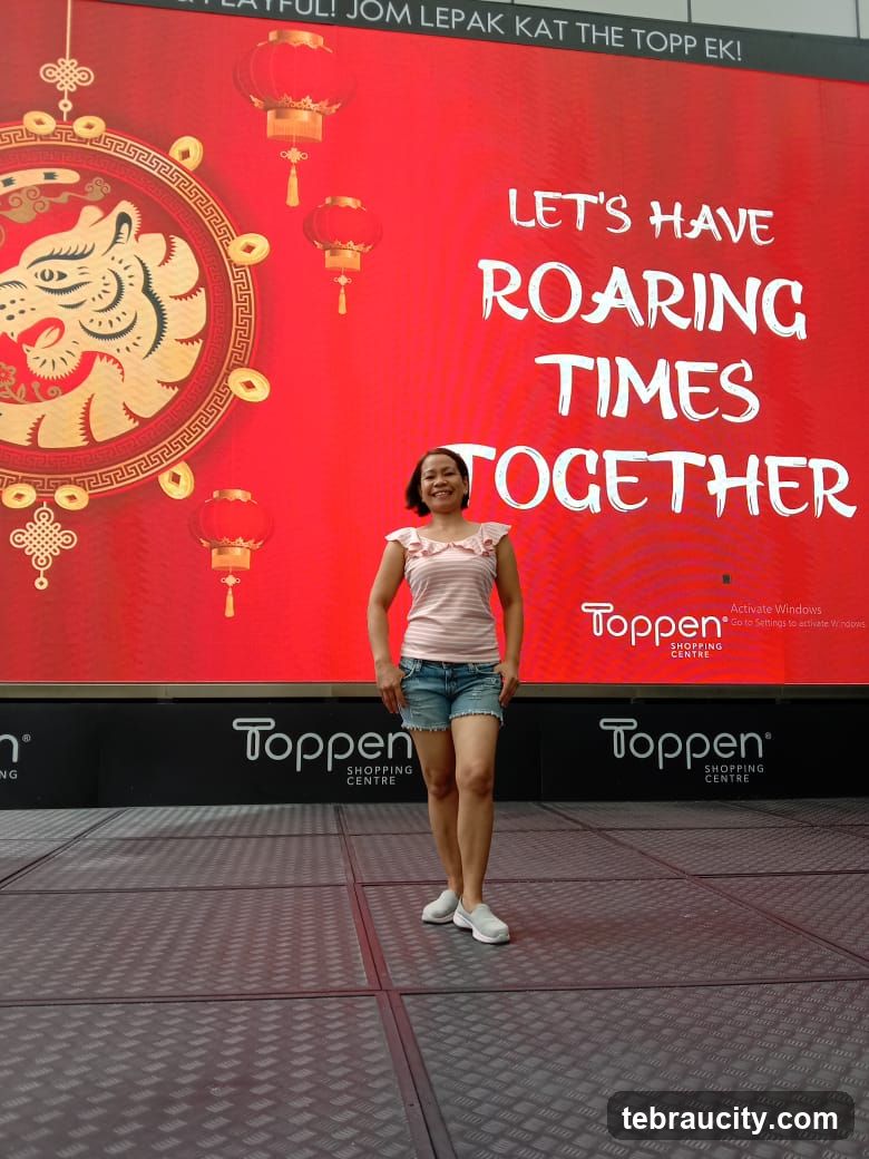 Woman Poses in Front of a Festive Digital Display