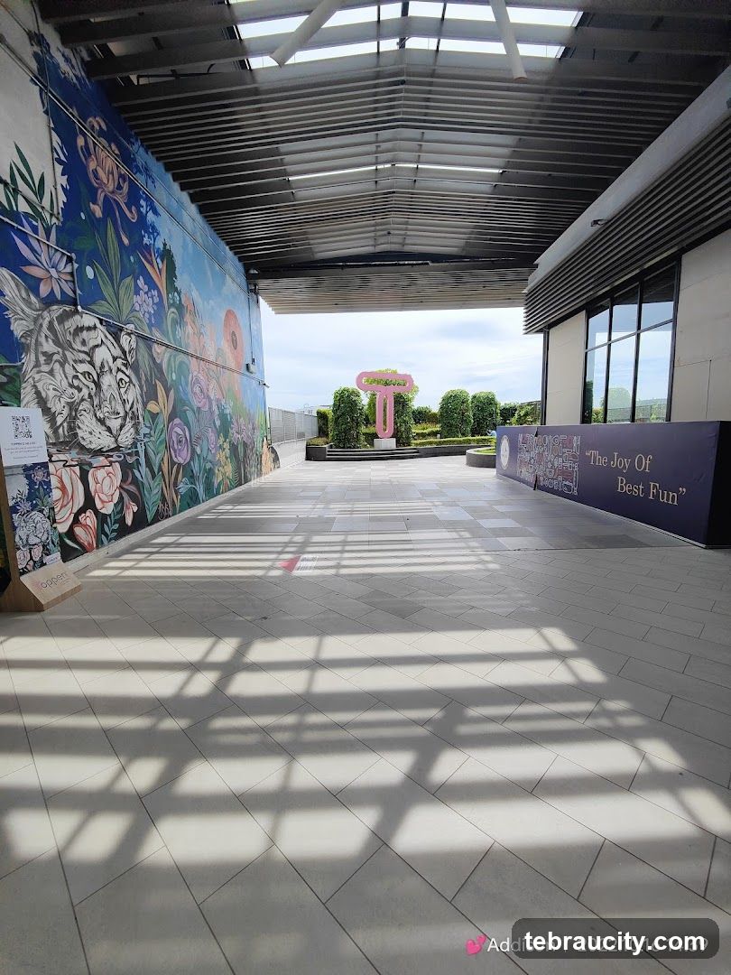 Outdoor walkway with mural and signage