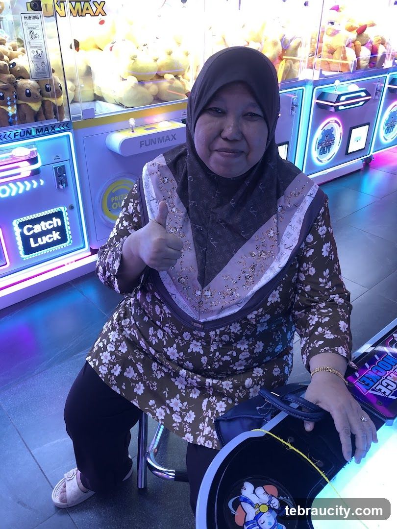 Woman giving a thumbs up in an arcade