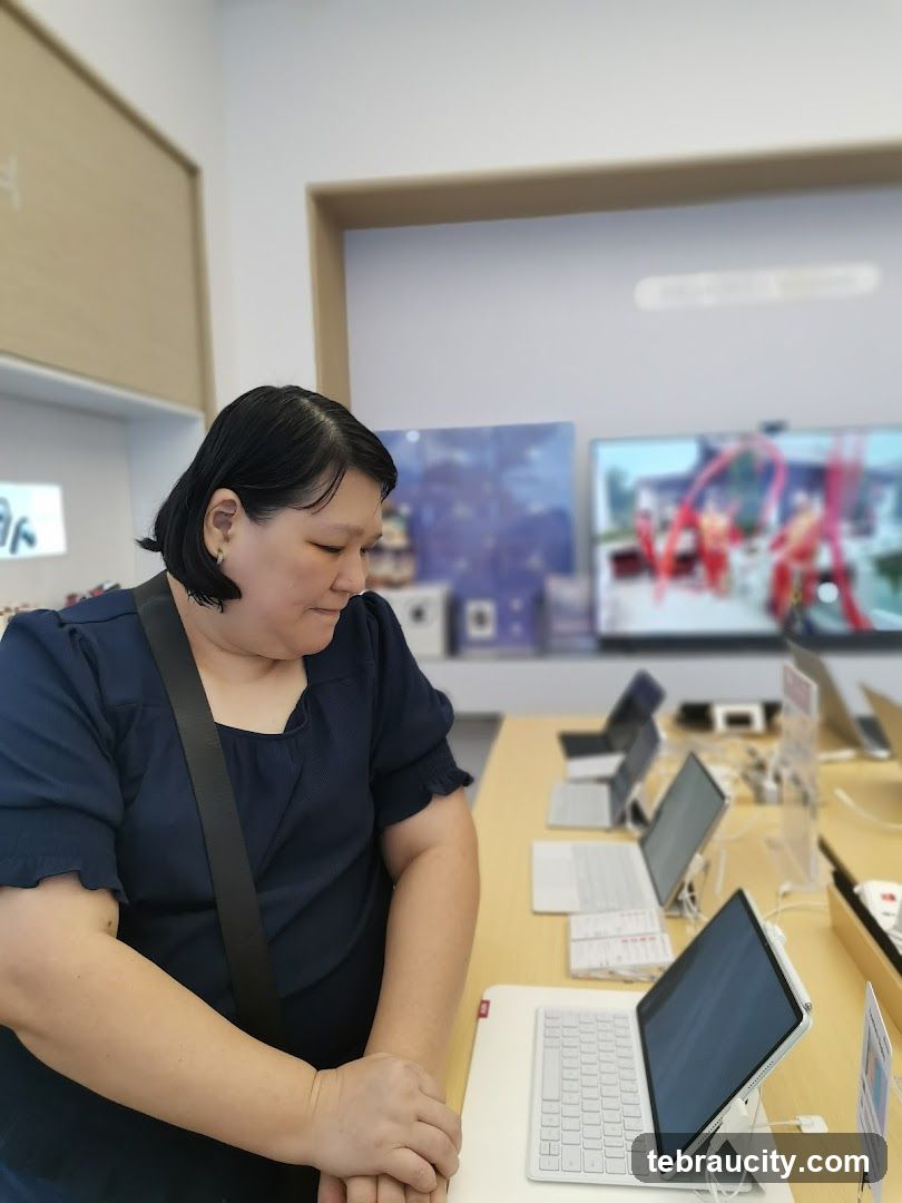 Woman looking at laptops in a store