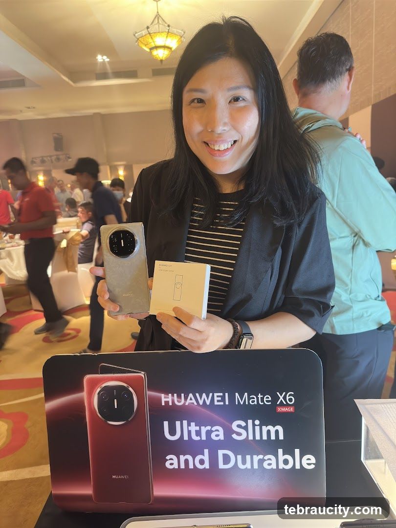 Woman holding Huawei Mate X6 phone and accessories