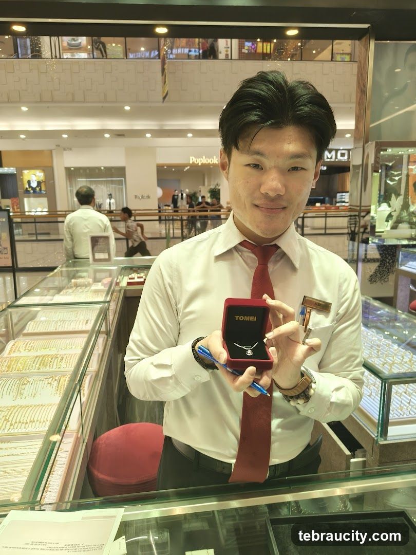 Jewelry store employee showing a necklace