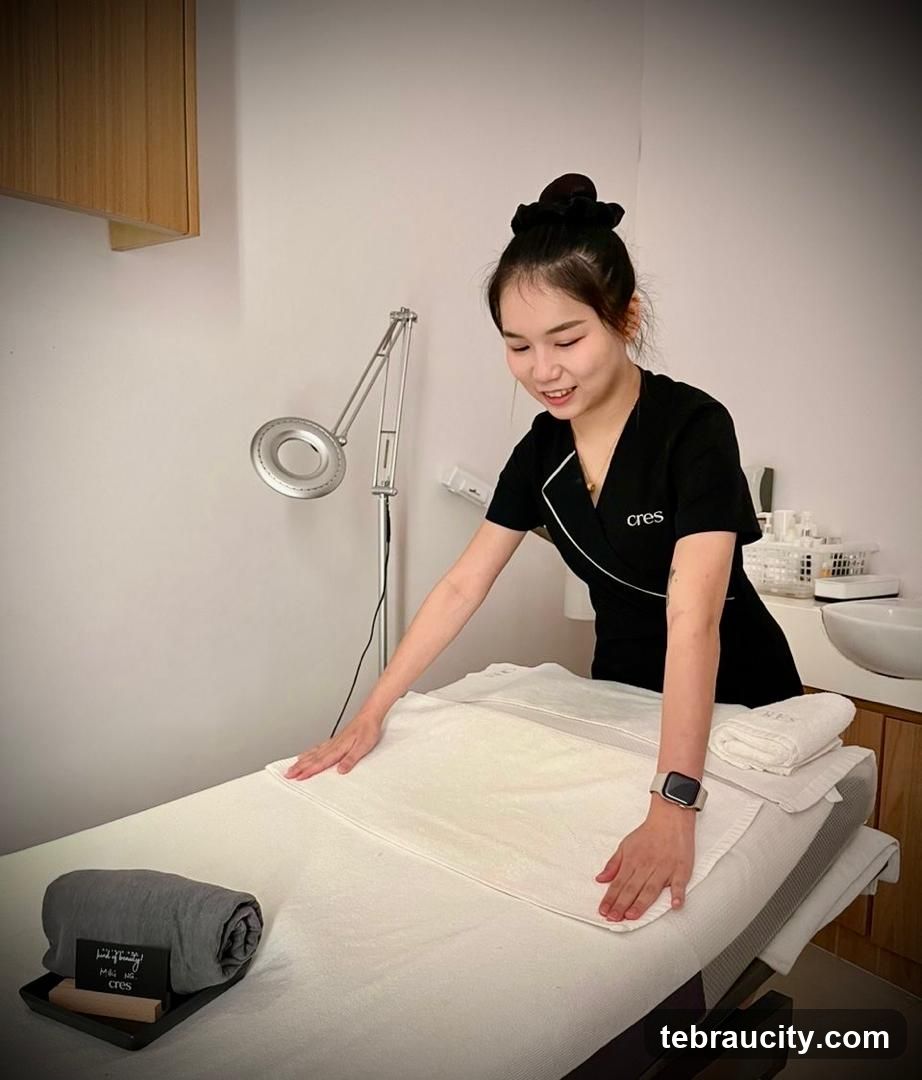 Spa worker preparing a treatment bed