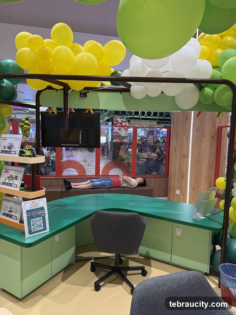 Man sleeping at a desk with balloons
