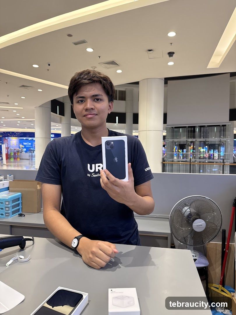 Man holding an iPhone box