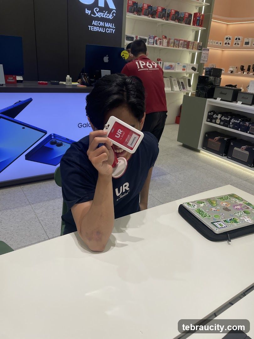 Person holding an ID badge in front of their face