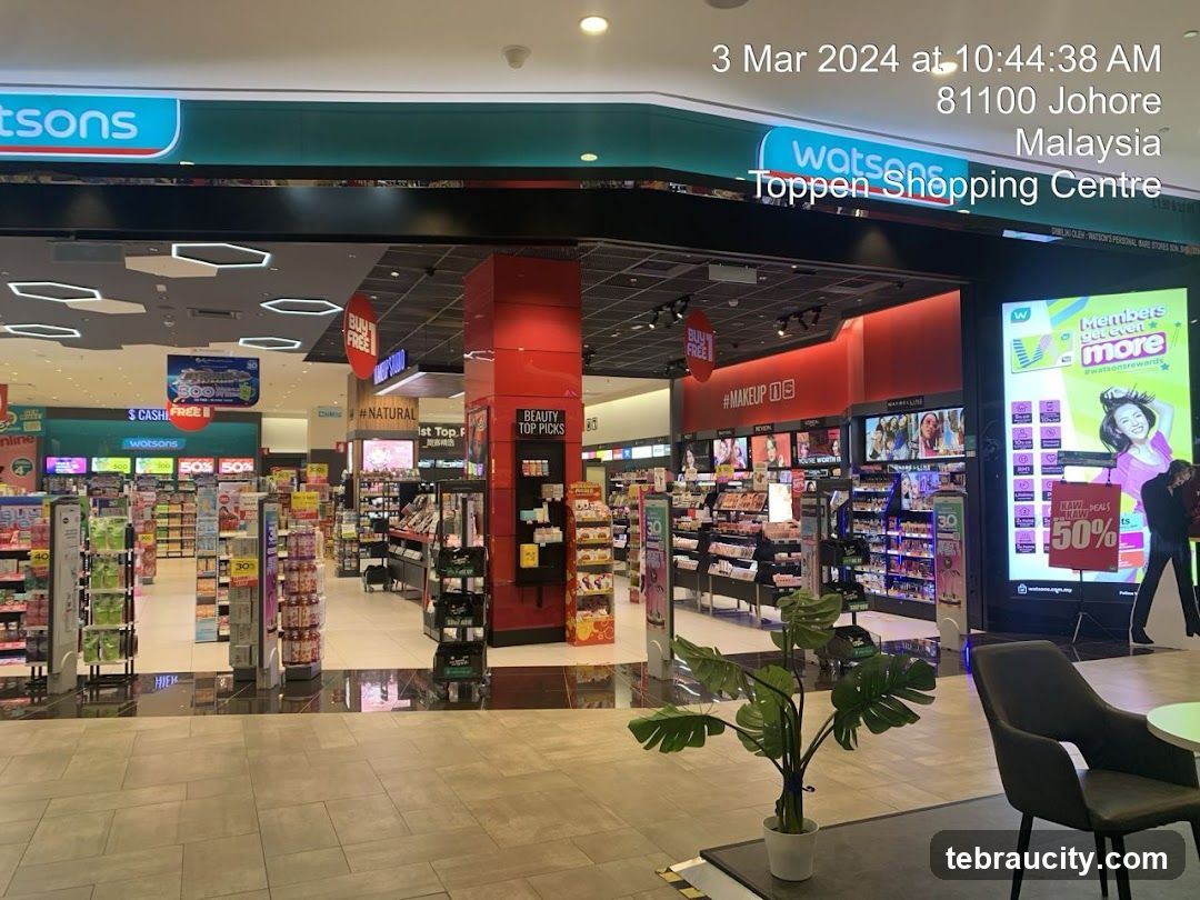 The exterior of a Watsons store located in Toppen Shopping Centre, Malaysia. The store features prominent Watsons branding and displays various beauty products and promotions.