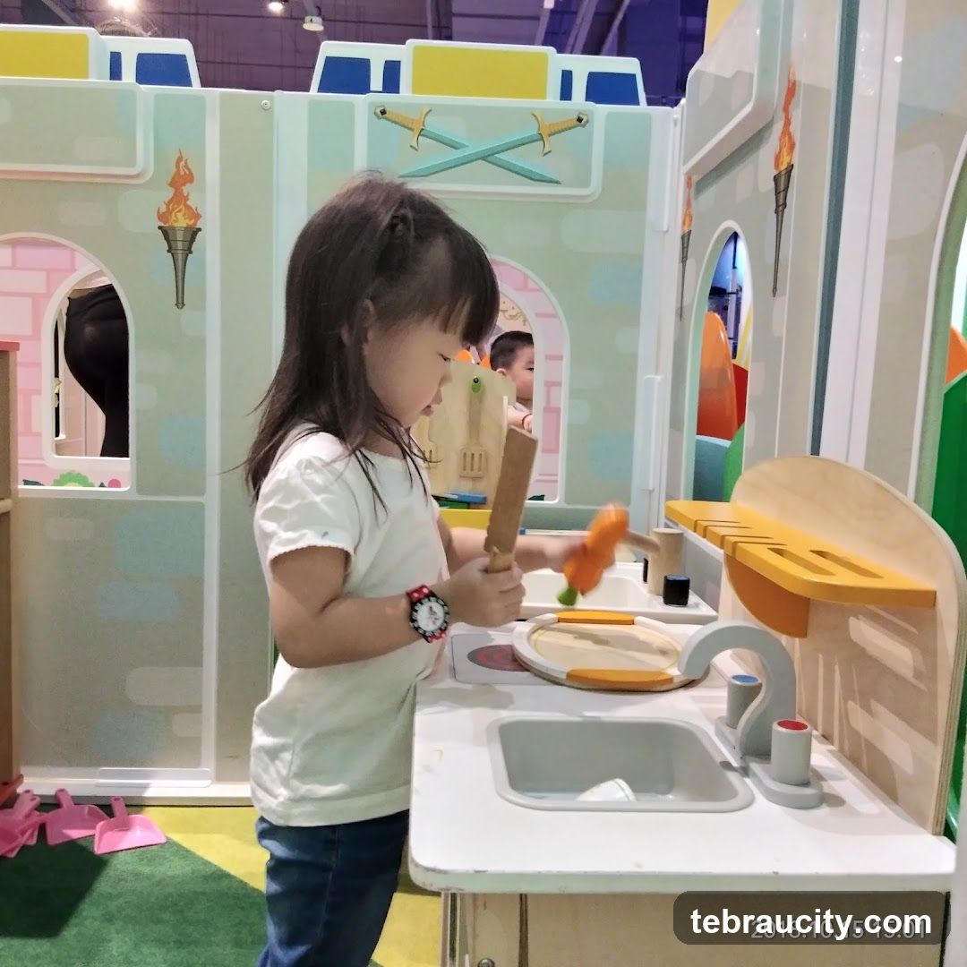 Child playing with toy kitchen