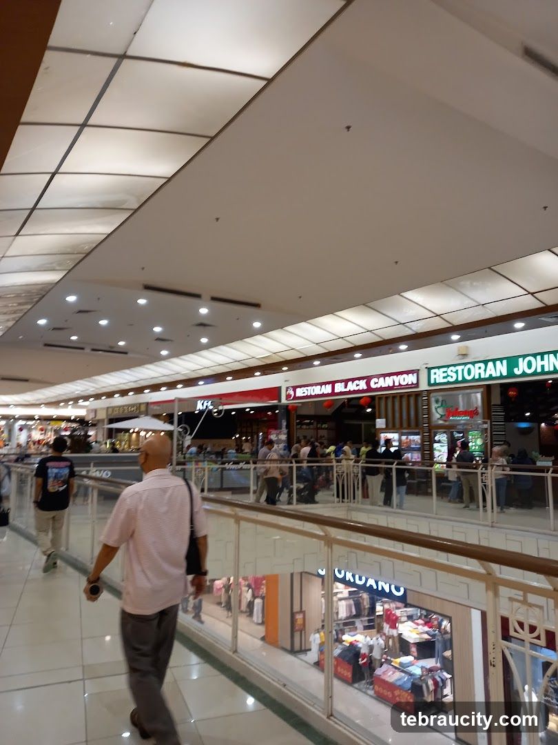 Indoor shopping mall with various stores and restaurants
