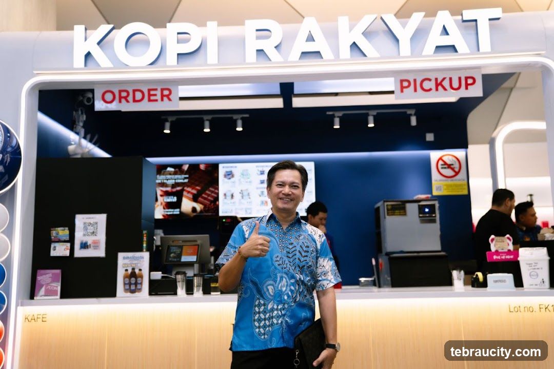 Man giving a thumbs up at a coffee counter