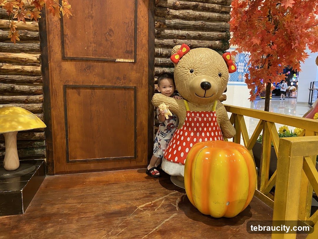 Child with bear statue in themed indoor area