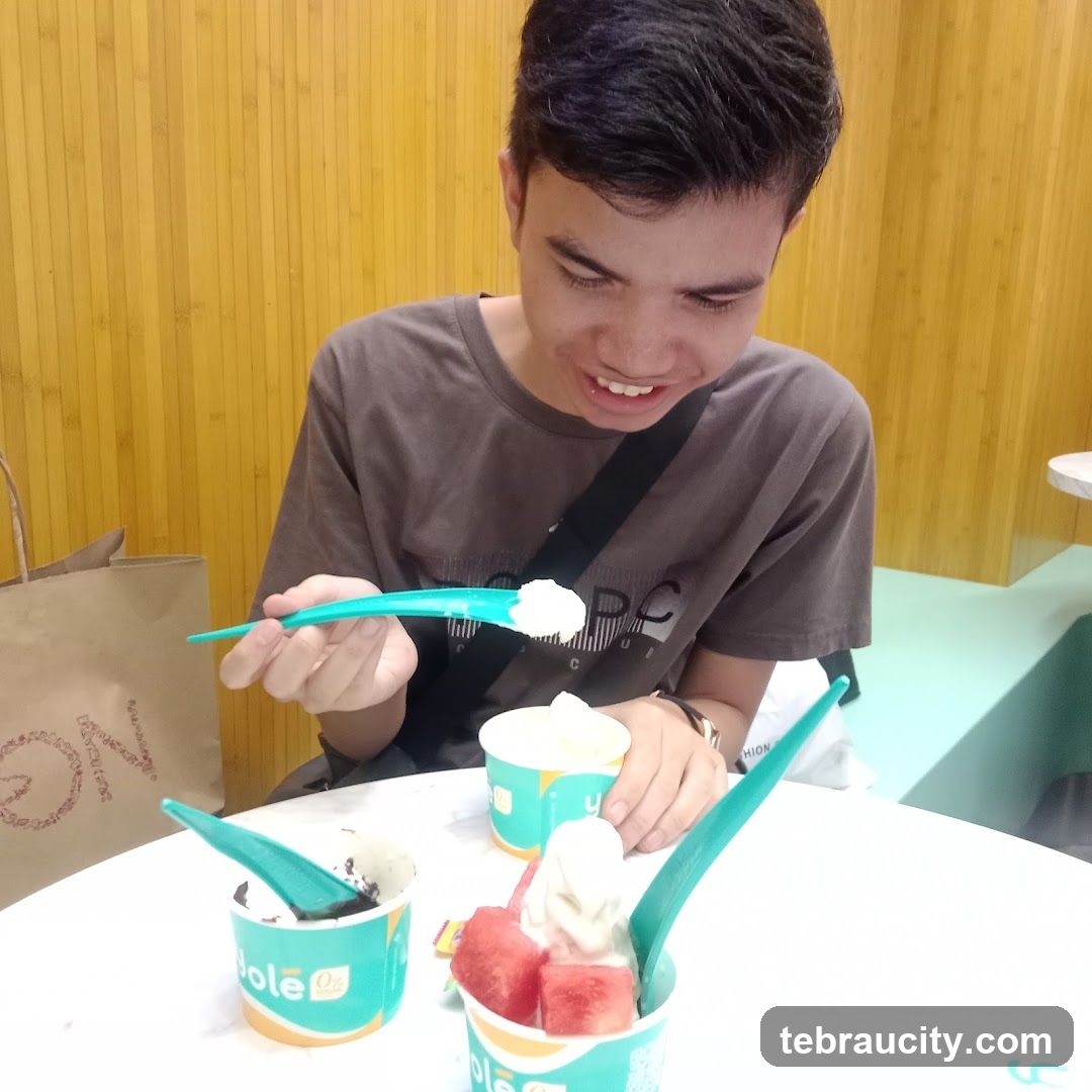Young man eating frozen yogurt