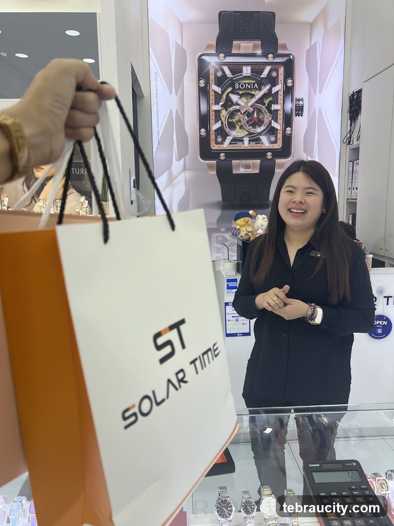 Woman holding shopping bag in watch store