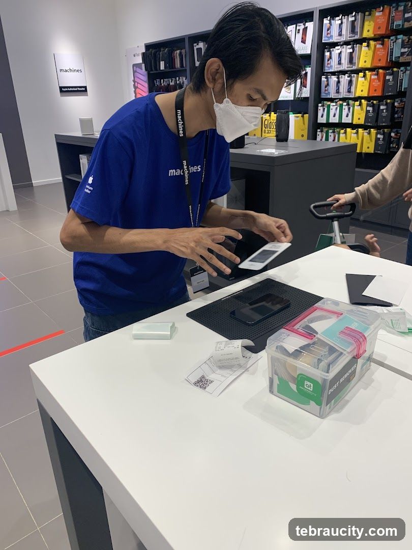Store employee applying screen protector