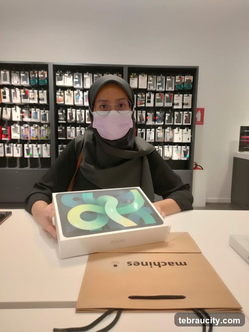 Woman holding an iPad Air box