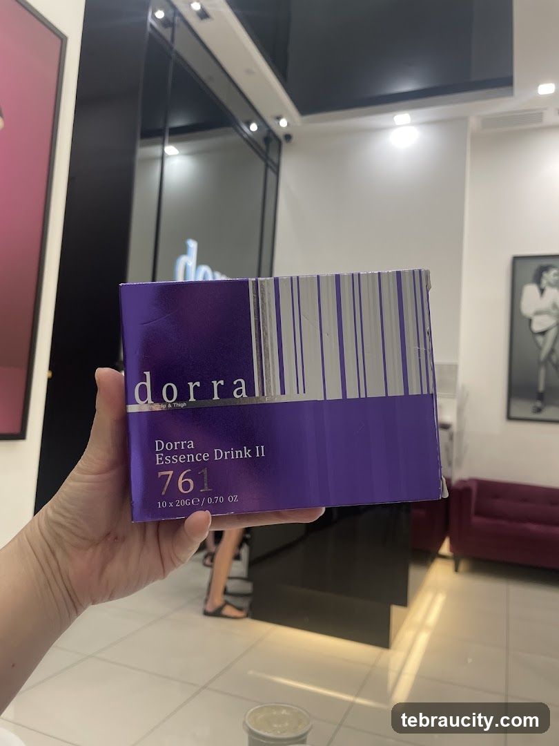 Hand holding Dorra Essence Drink II box