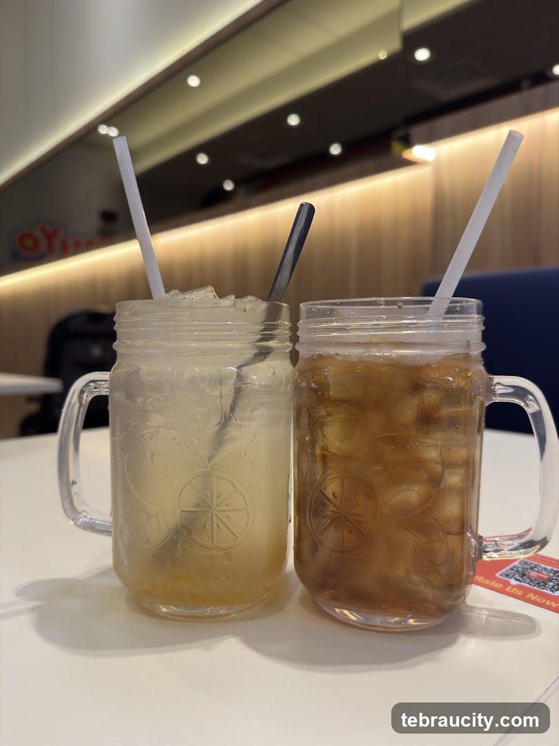 Two iced beverages in mason jars on a table