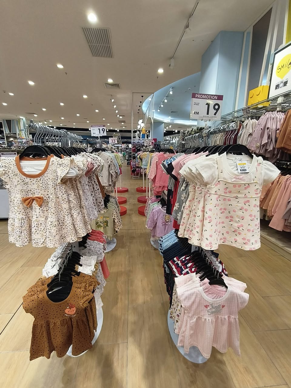 Baby girl clothing with RM15 promotional pricing on T-shirts and dresses