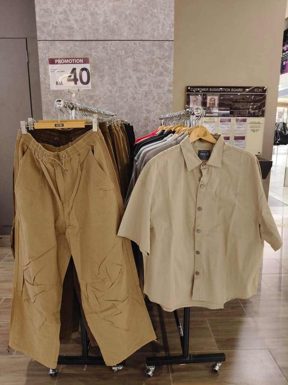 Tan cargo trousers and beige button-up shirt at RM40 promotion