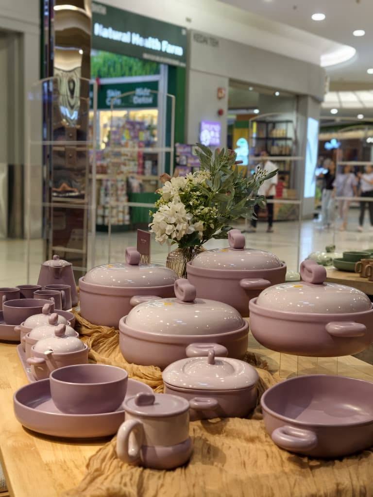 Pink ceramic cookware display at the Color King Mid-Autumn event
