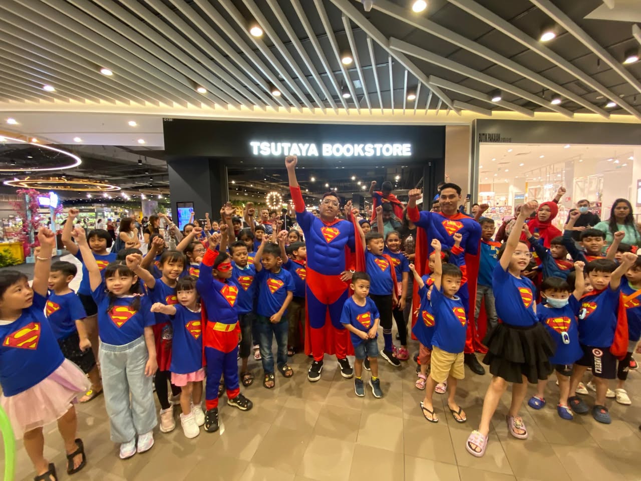 A group of enthusiastic Superman parade participants smiling.