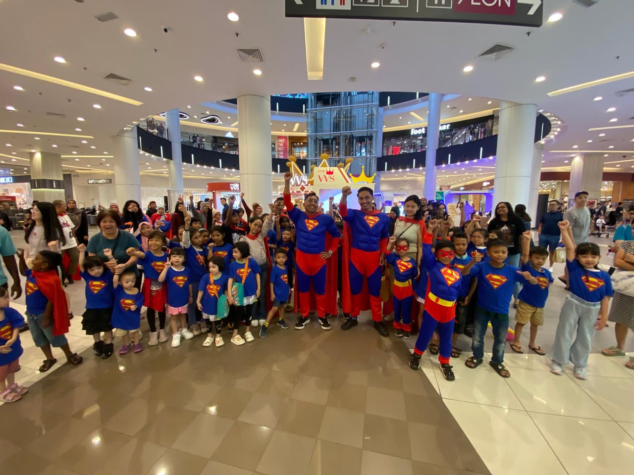 Crowd of Superman costume parade participants inside AEON MALL Tebrau City.