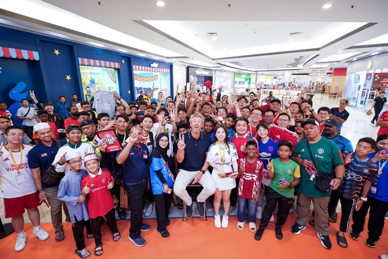 Edwin van der Sar posing with fans during a meet-and-greet session