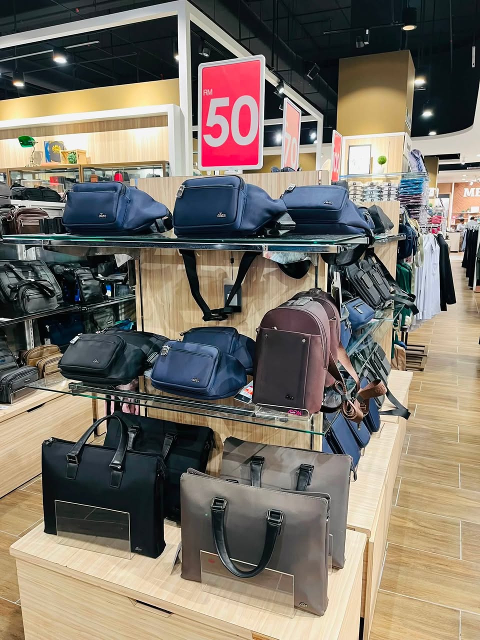 Men's leather bags and briefcases on shelves