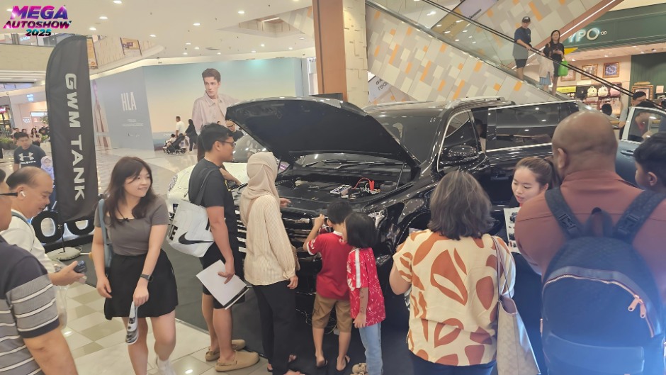 Visitors interacting with GWM vehicles at the auto show