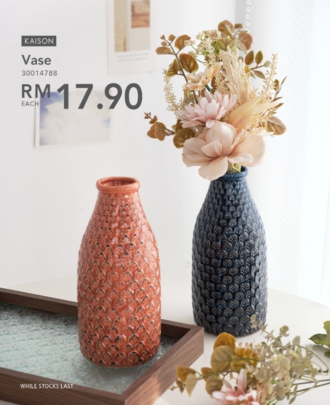 A Kaison vase with artificial flowers on a minimalist shelf, adding a touch of green.