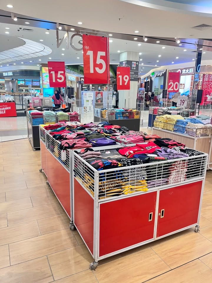 Paradise Sale display with folded garments at TQ Day