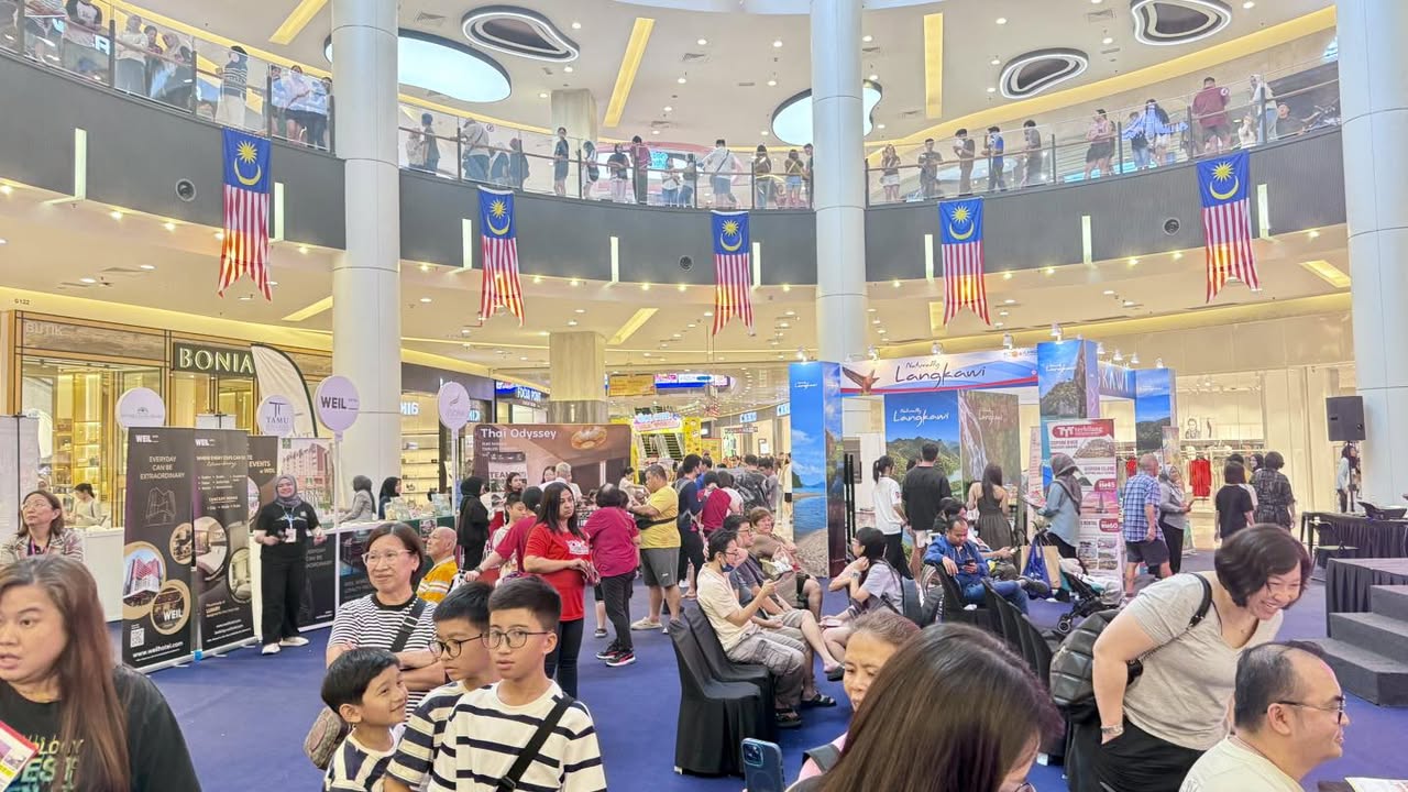 Visitors exploring various travel booths and offers at the MAH Tourism Fair