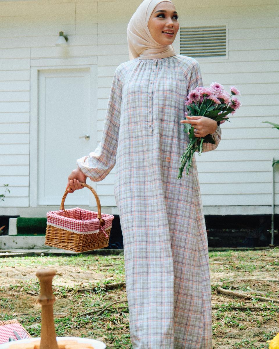 Woman wearing a gingham dress from the Gingham Skies collection.