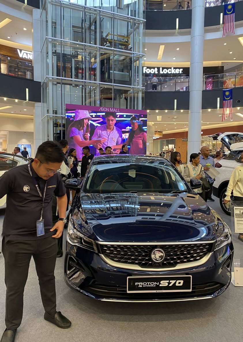 Visitors engaging with a Proton vehicle at the AEON Mall roadshow.
