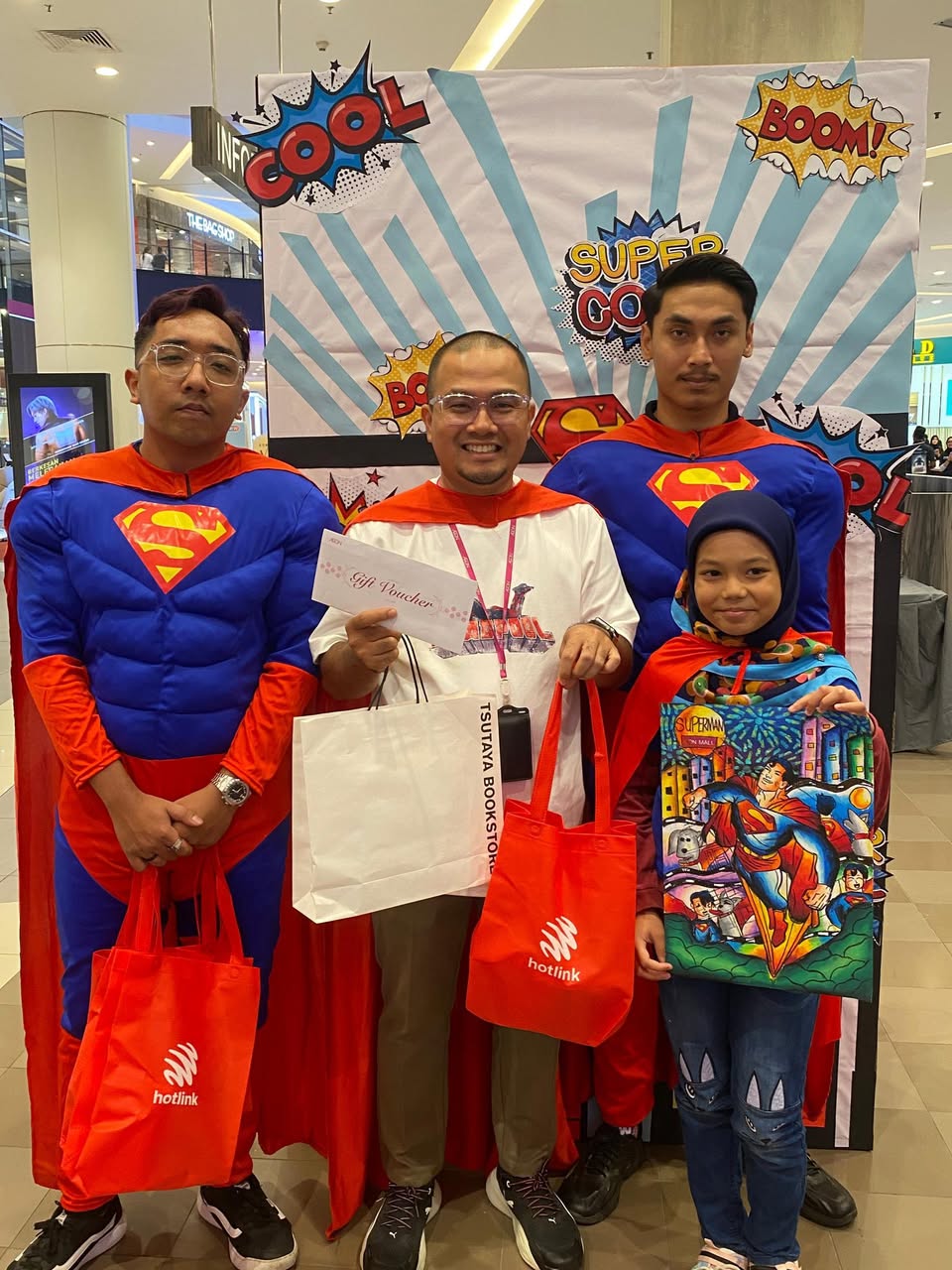 A child focused on coloring their Superman drawing at the event.