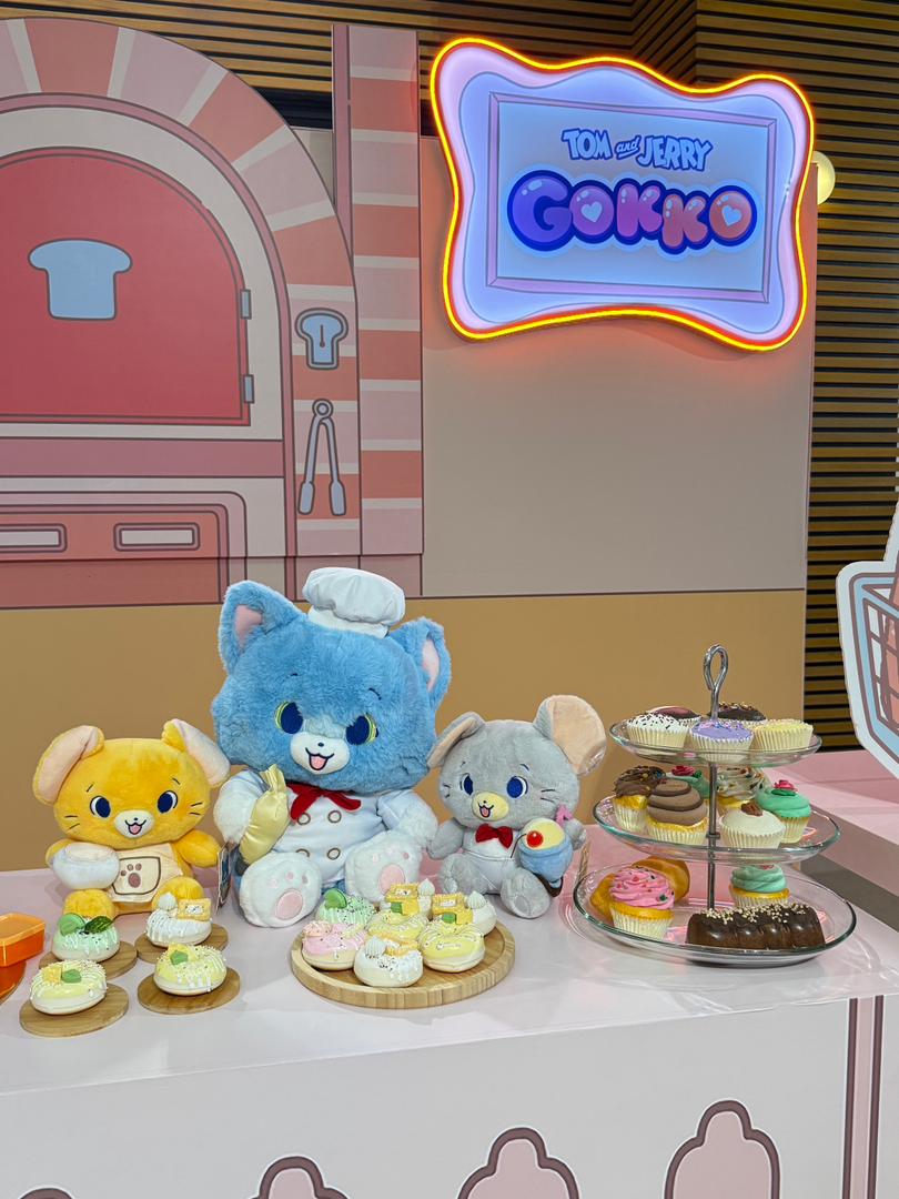 Visitors interacting with fun, oversized Tom & Jerry character cutouts at a dedicated photo booth.
