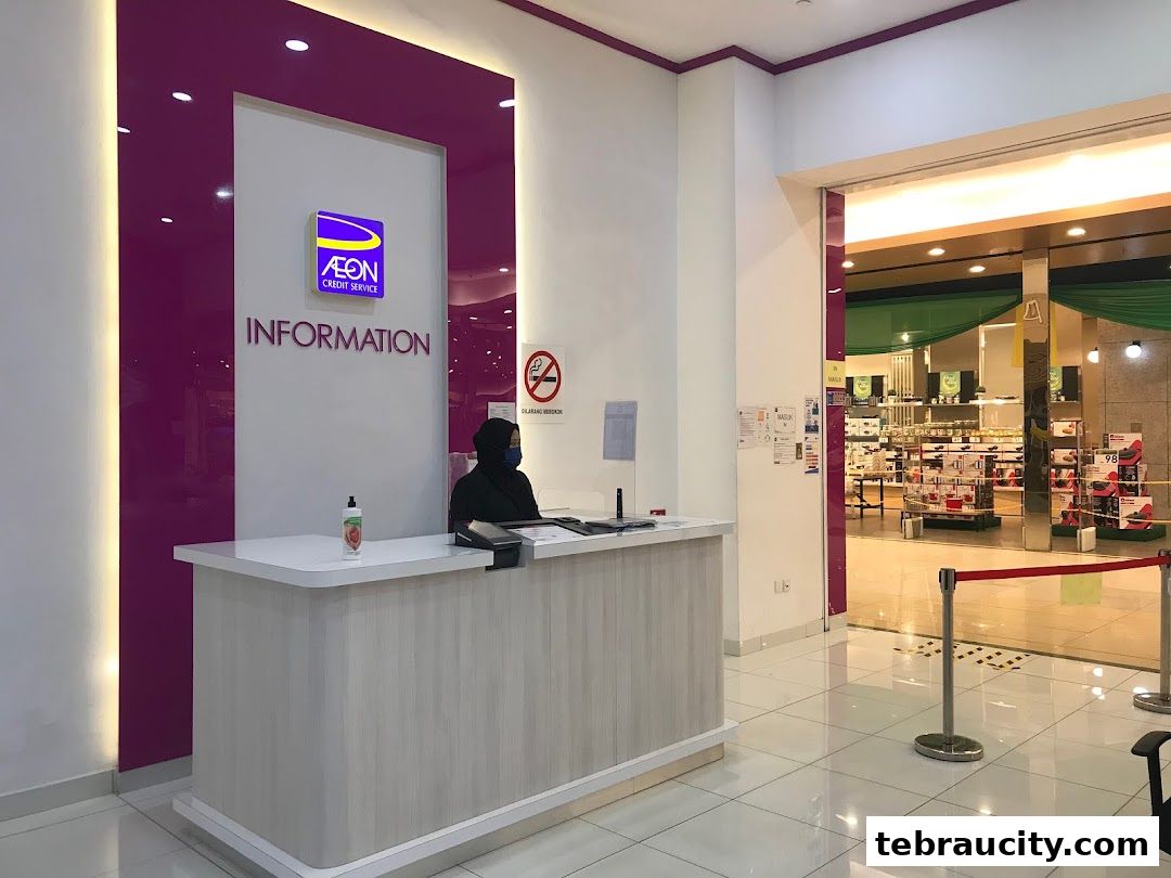 An information counter at AEON Credit Tebrau City with a staff member present.