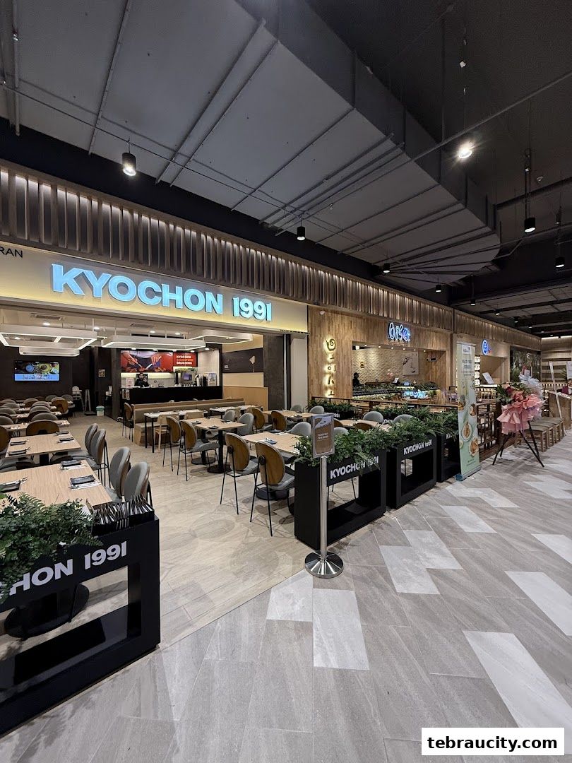 Interior view of a Kyochon 1991 restaurant with tables and chairs set up.