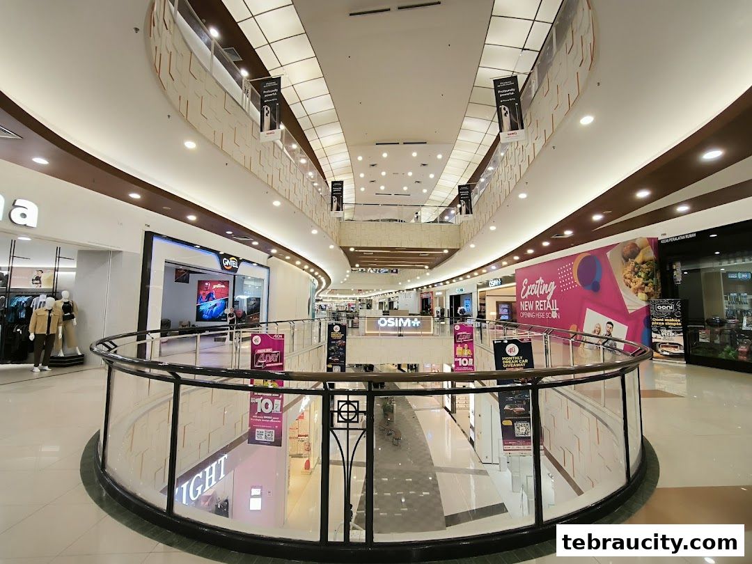 Interior view of a modern shopping mall with multiple levels and shops.