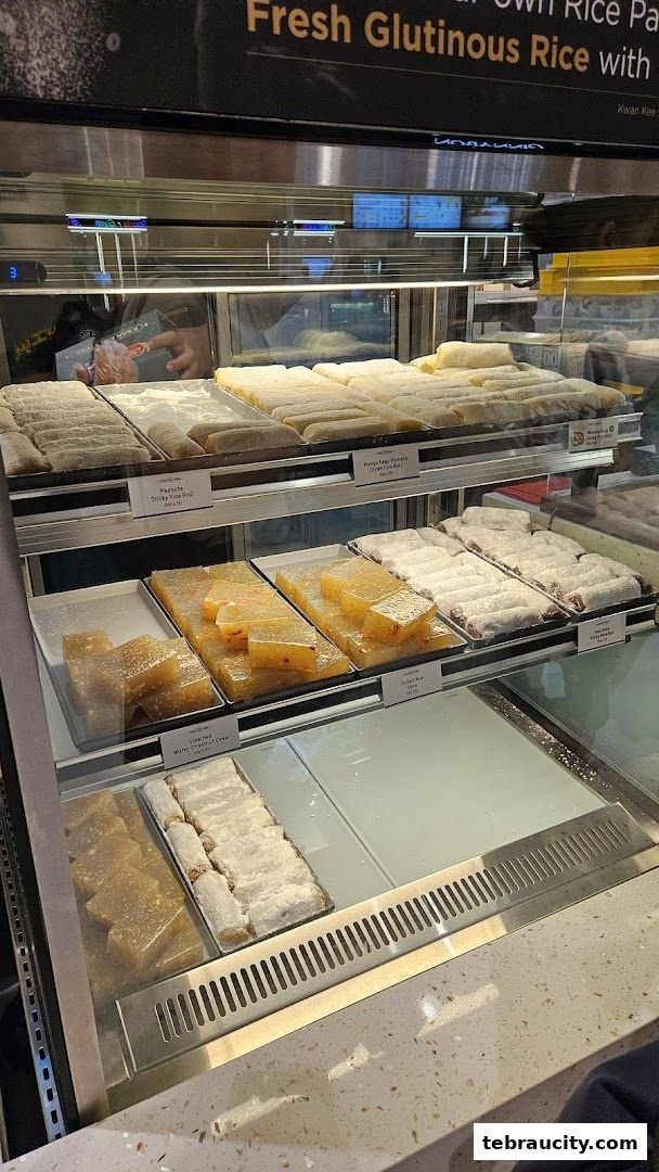 A display case filled with various types of glutinous rice cakes and desserts.