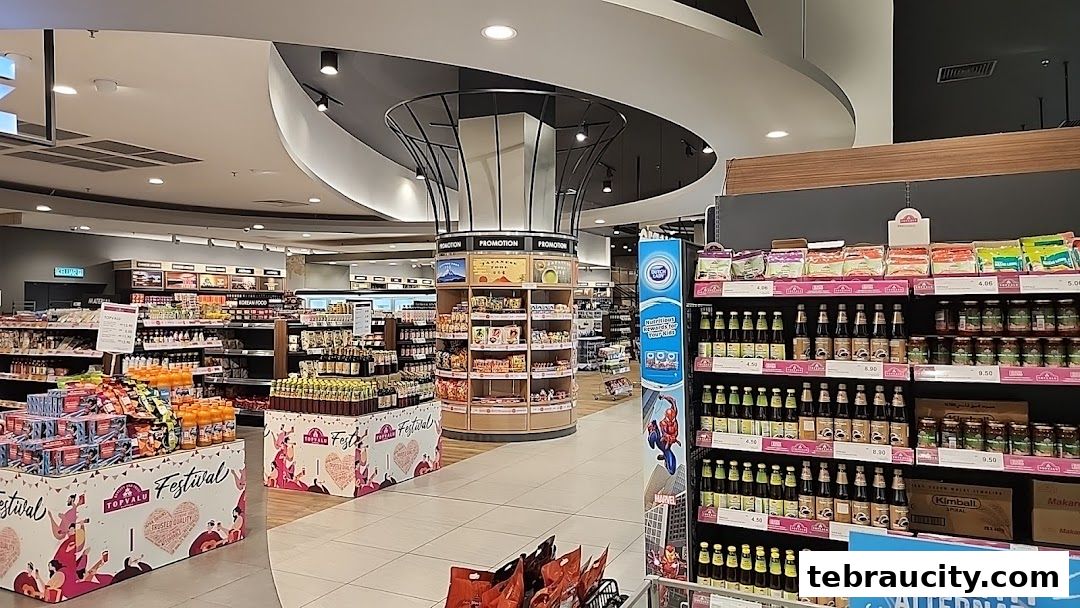 Interior view of a well-stocked supermarket with aisles of food products and promotional displays.