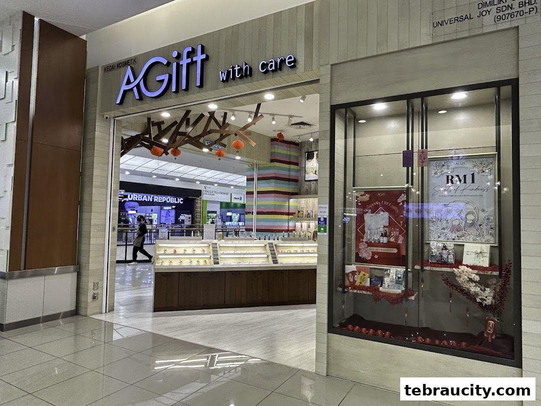 The storefront of AGift with care, a cosmetics shop, featuring a display window with promotional posters.