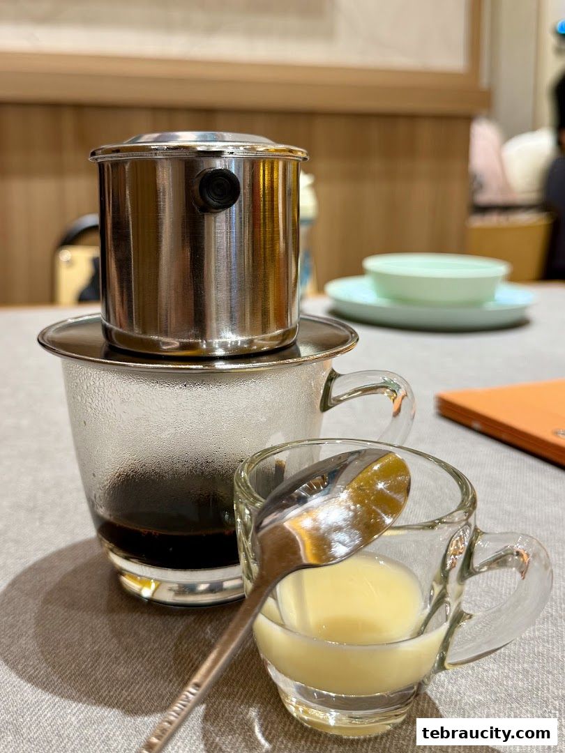 A close-up of a Vietnamese coffee being prepared with condensed milk.