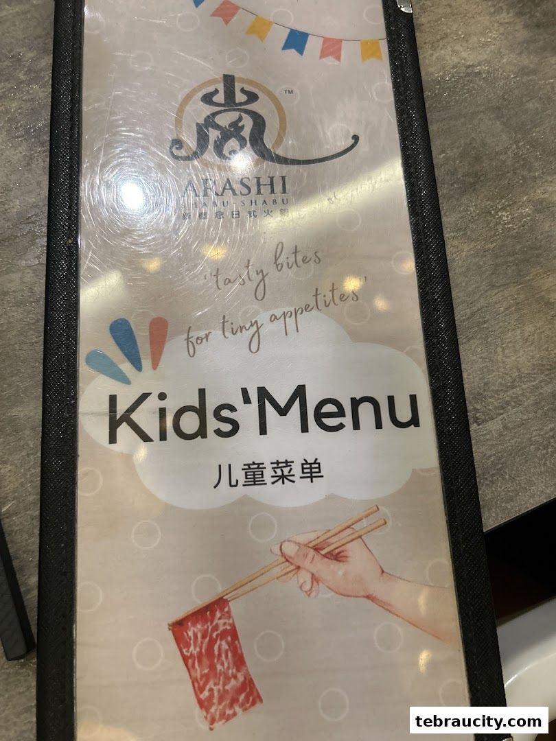 A menu for Arashi Shabu-Shabu featuring a kids' menu with a drawing of meat and chopsticks.